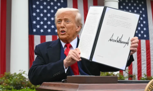 US President Donald Trump holds a signed executive order after delivering remarks on reciprocal tariffs during an event in the Rose Garden called 'Make America Wealthy Again' at the White House in Washington, DC. (Photo by AFP)