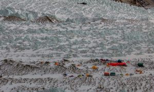 A Pakistani army helicopter flies over K2 base camp on February 25, 2018. A Russian-Polish mountaineer has launched the first solo attempt to summit Pakistan's K2