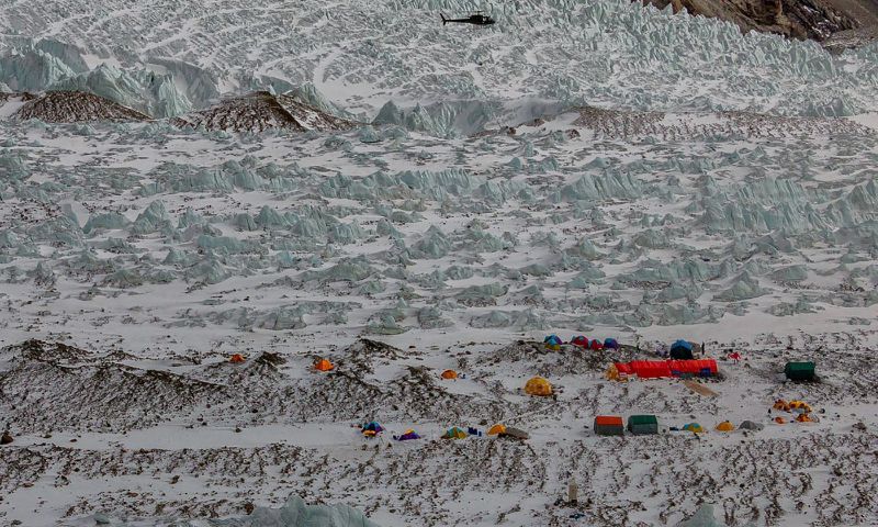 A Pakistani army helicopter flies over K2 base camp on February 25, 2018. A Russian-Polish mountaineer has launched the first solo attempt to summit Pakistan's K2
