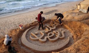 "Welcome Ramadan" is sculpted in sand on a Gaza beach